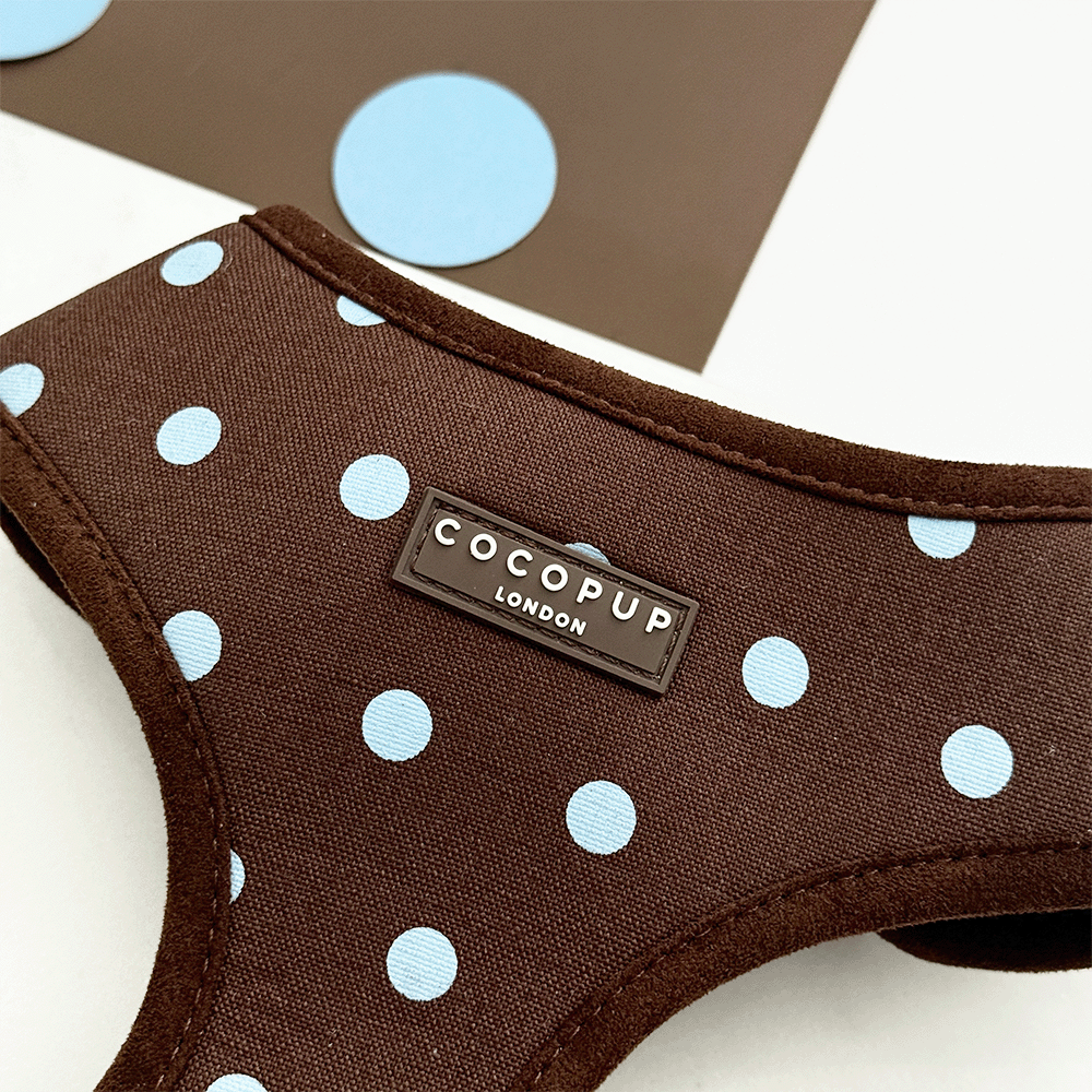 A brown dog harness with light blue polka dot design. Featuring brown hardware.