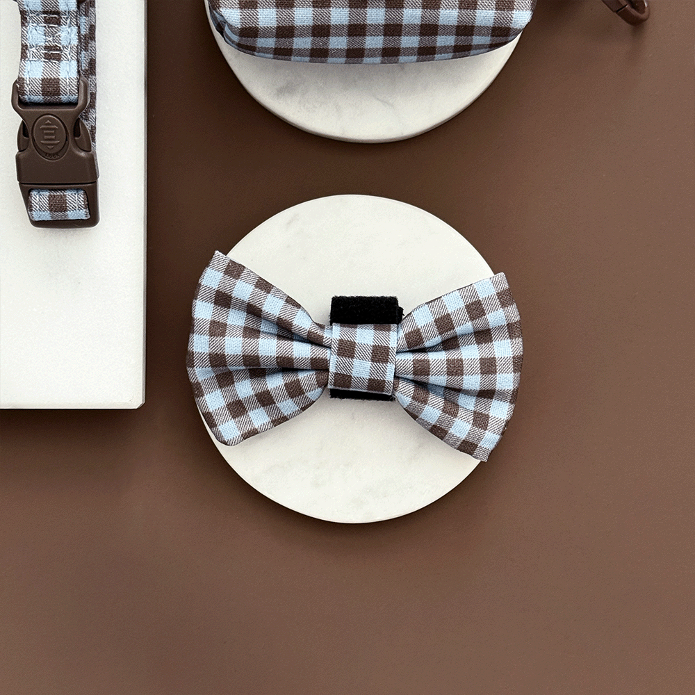 A brown and blue check print bow tie for dogs. With velcro fastening.