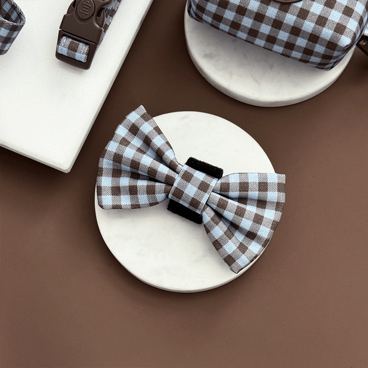 A brown and blue check print bow tie for dogs. With velcro fastening.