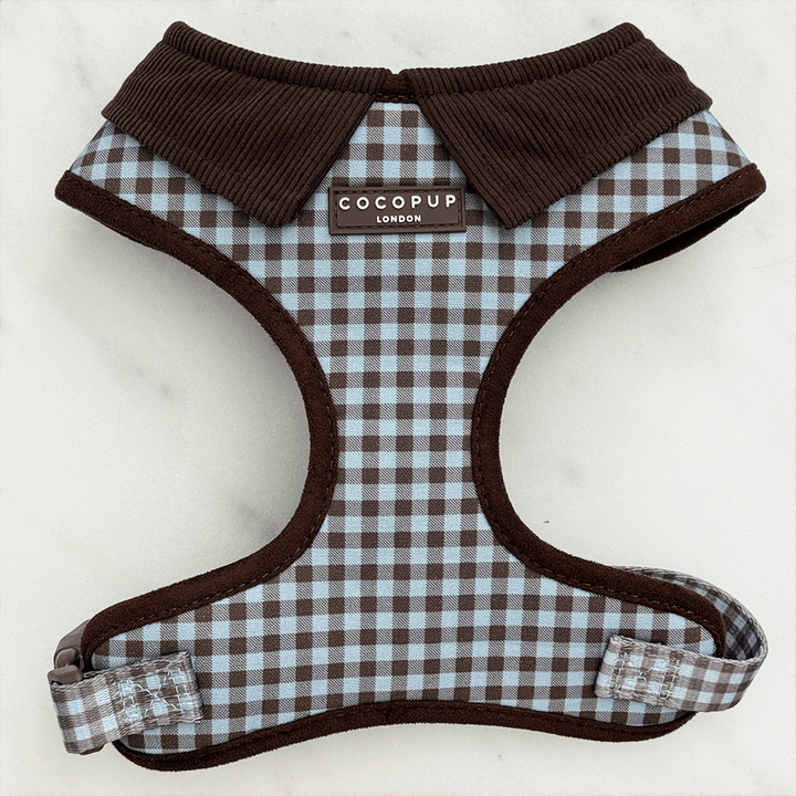 A brown and blue check print dog harness. With brown hardware and brown corduroy collar detail.