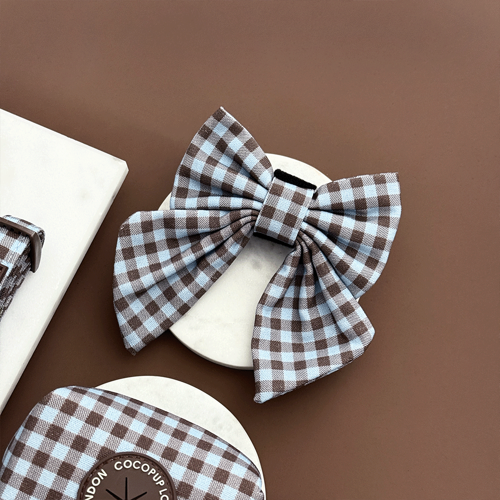 A brown and blue check print sailor bow tie for dogs. With velcro fastening.