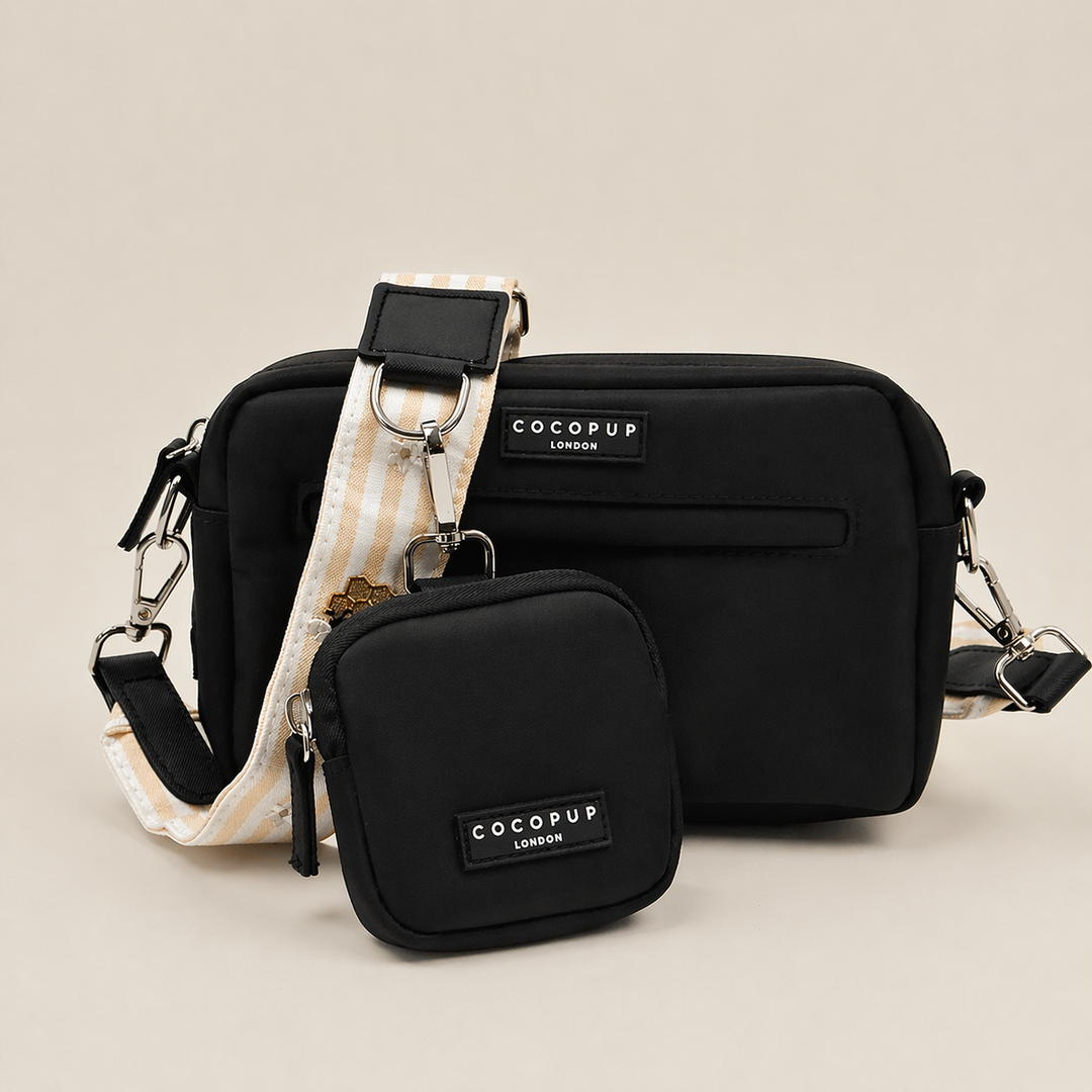 Cocopup black Dog Walking Bag with pale yellow and white striped Bag Strap with bee and honeycomb embroidered decals. Attached is a Cocopup Treat Pouch in black.