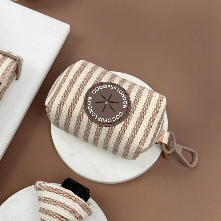 Brown and beige striped pouch with a hole to put poop bags through. 
