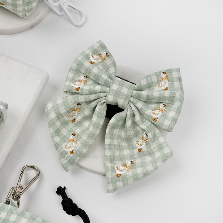 Green and white check print dog sailor bow tie with embroidered geese design.