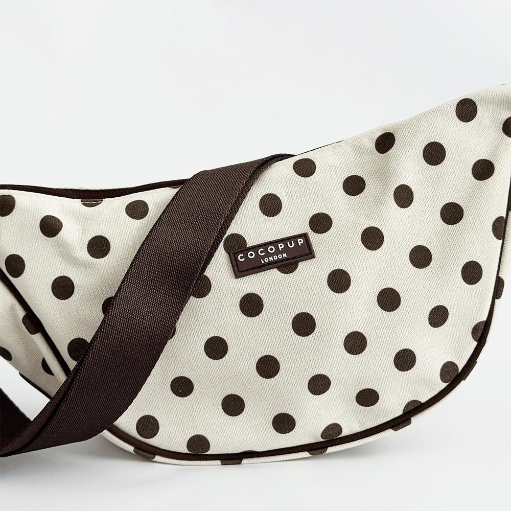 Polka dot pet carrier with 'CocoPup London' label on a white background