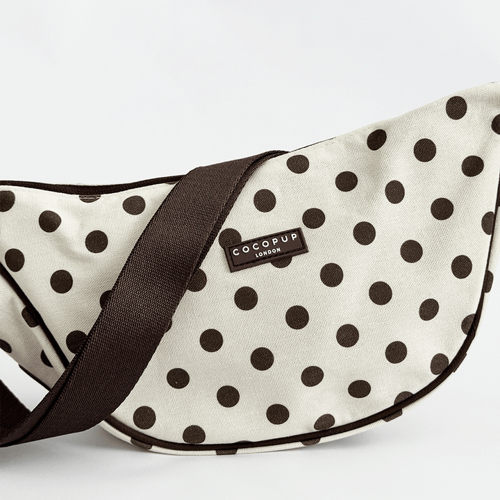 Polka dot pet carrier with 'CocoPup London' label on a white background