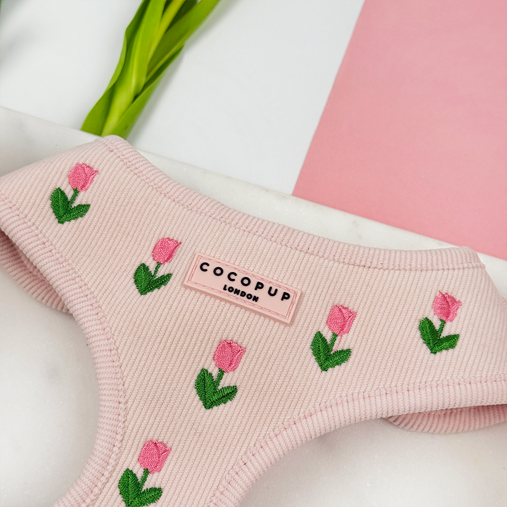 Pink dog harness with tulip embroidered design. Cocopup logo.